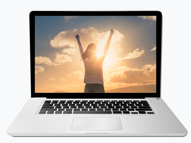 A laptop showing someone celebrating at sunrise